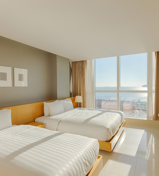 Panoramic ocean view from the guestroom window at Sono Calm Yeosu