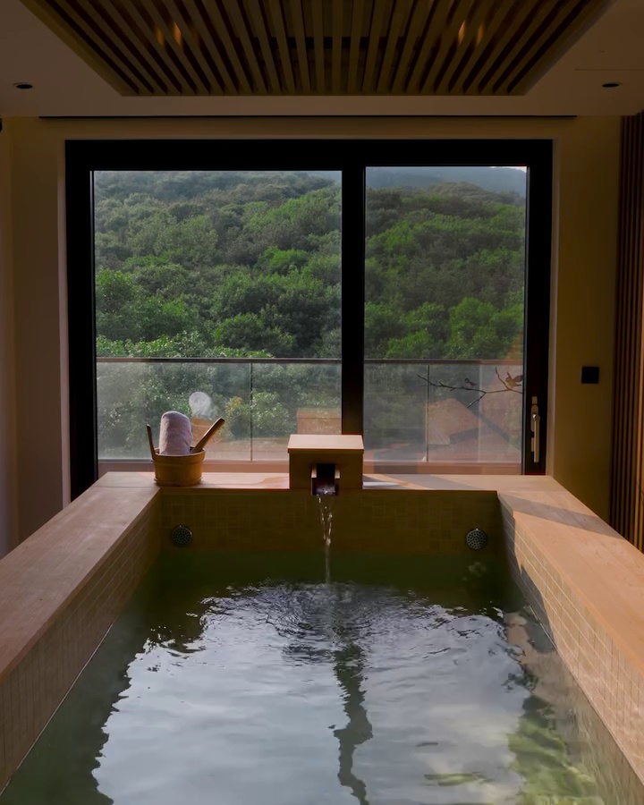 Private in-room Hinoki cypress bathtub with natural mineral water facing the Bukhansan forest at ANTO Resort Seoul