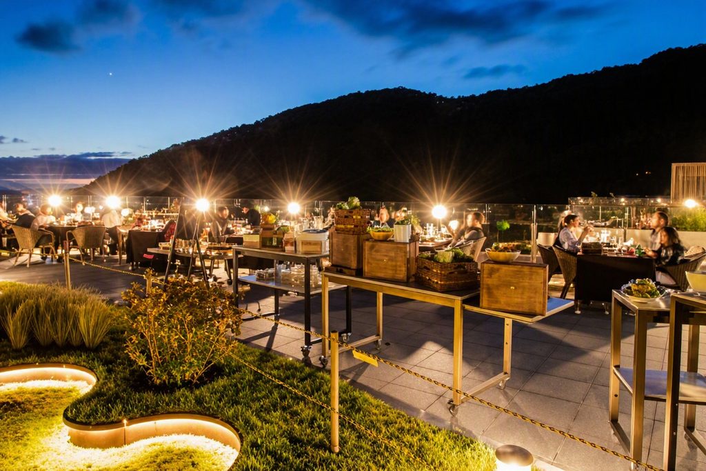 Outdoor BBQ dining table set on the terrace with mountain autumn foliage and observatory dome at Forest Resom
