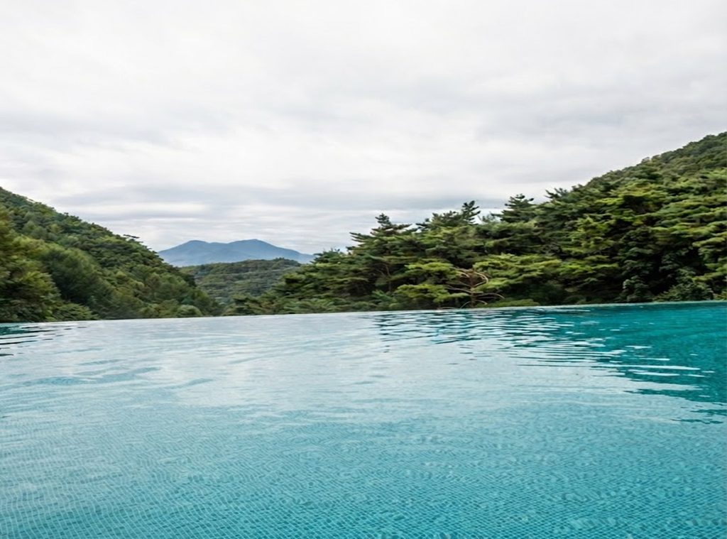 Heated outdoor infinity pool at Have9 Healing Spa overlooking scenic mountain ridges at Forest Resom
